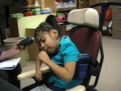 sound level meter held close to child's head
